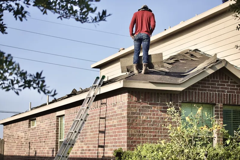 Professional roofer working on a residential roof in Lincoln Village